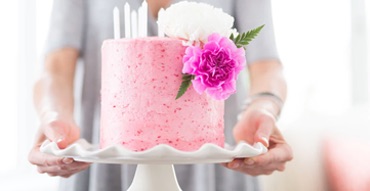 Photo of a a lady holding a cake